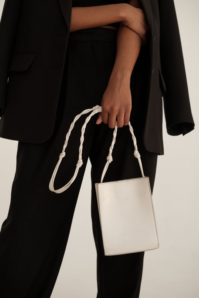 Woman in Black Outfit and White Purse